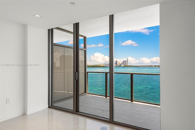 entryway with expansive windows and a water view