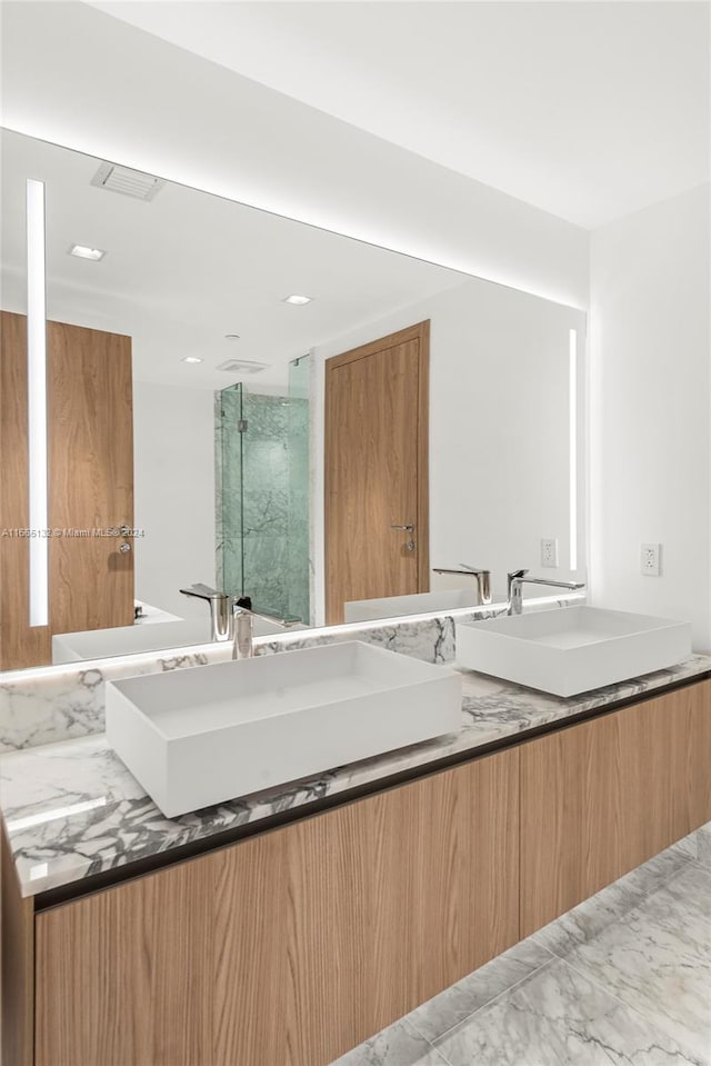 bathroom featuring vanity and a shower with door