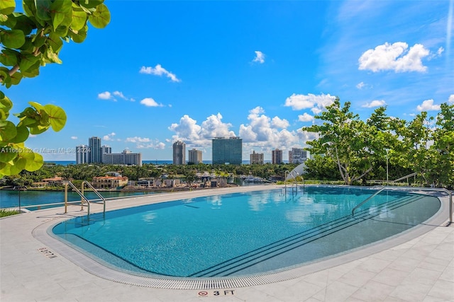 view of pool with a water view