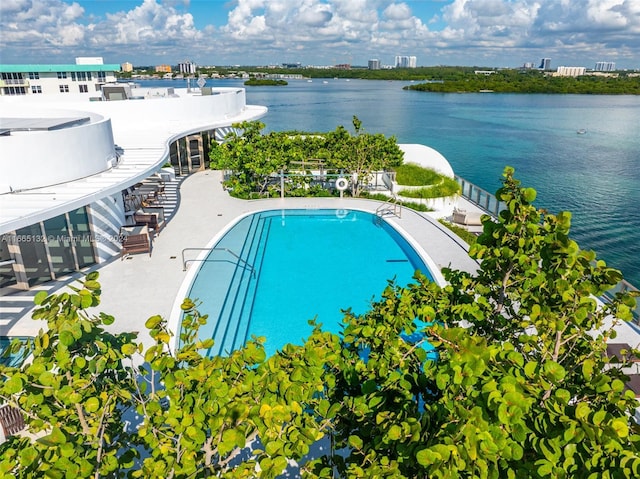 view of pool with a water view