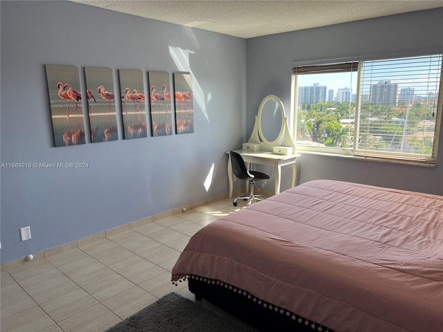 tiled bedroom with a textured ceiling