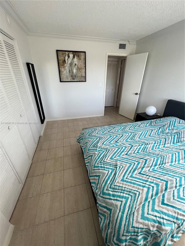 bedroom with a closet and a textured ceiling