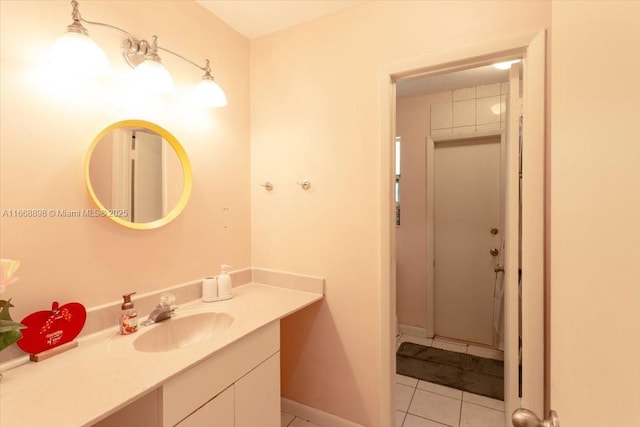 bathroom featuring vanity, baseboards, and tile patterned floors