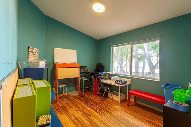 rec room featuring vaulted ceiling and wood finished floors