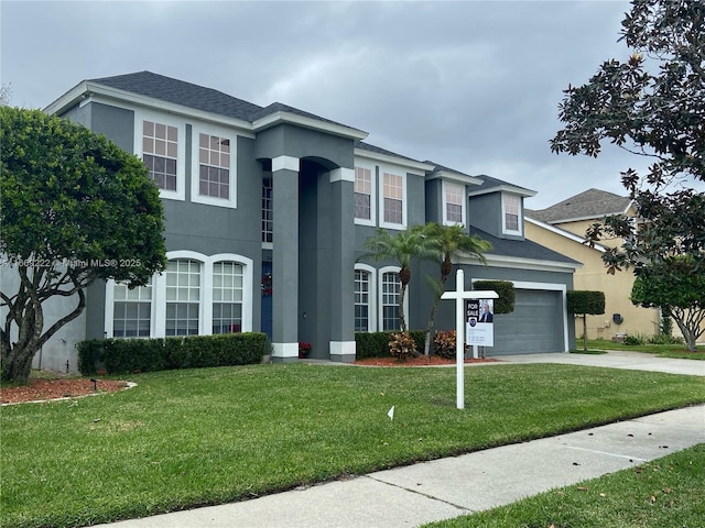 view of front facade featuring a front yard and a garage