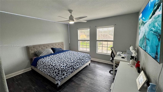 bedroom with ceiling fan, dark hardwood / wood-style flooring, and a textured ceiling