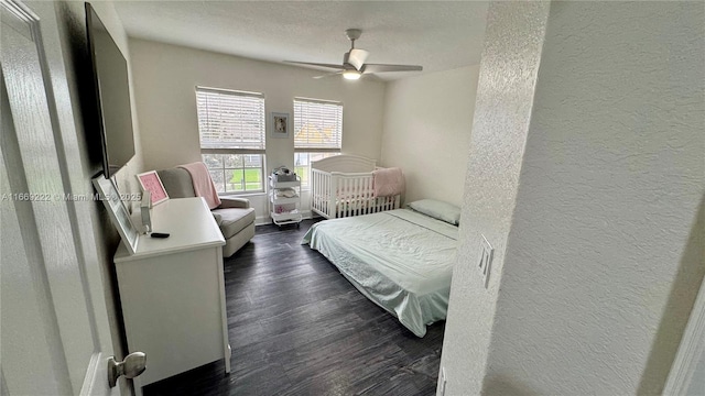 bedroom with ceiling fan and dark hardwood / wood-style floors