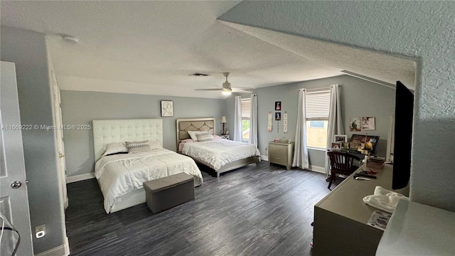 bedroom featuring a textured ceiling, vaulted ceiling, ceiling fan, and dark wood-type flooring