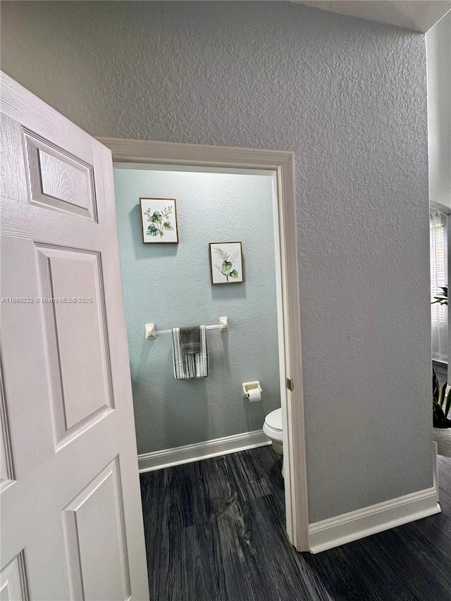 bathroom featuring hardwood / wood-style flooring and toilet