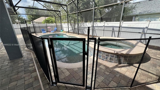 view of swimming pool featuring a lanai, an in ground hot tub, and a patio