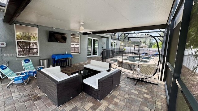 view of patio / terrace with an outdoor hangout area, ceiling fan, a lanai, an in ground hot tub, and a grill