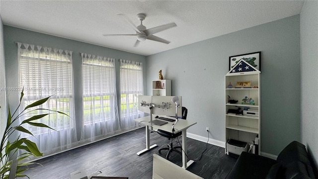 home office featuring ceiling fan, dark wood-type flooring, and a wealth of natural light