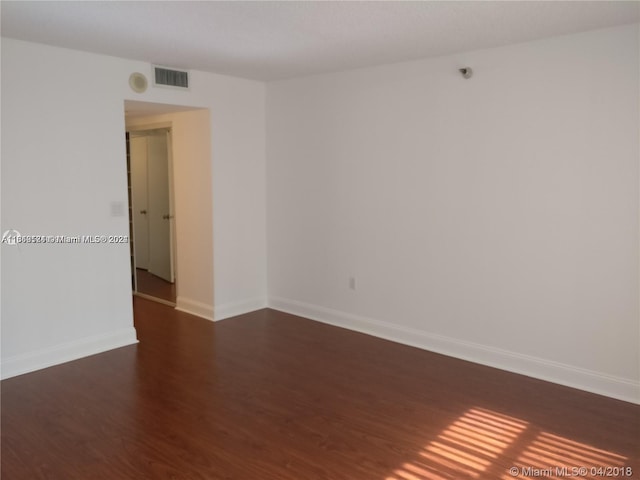 spare room with dark hardwood / wood-style floors