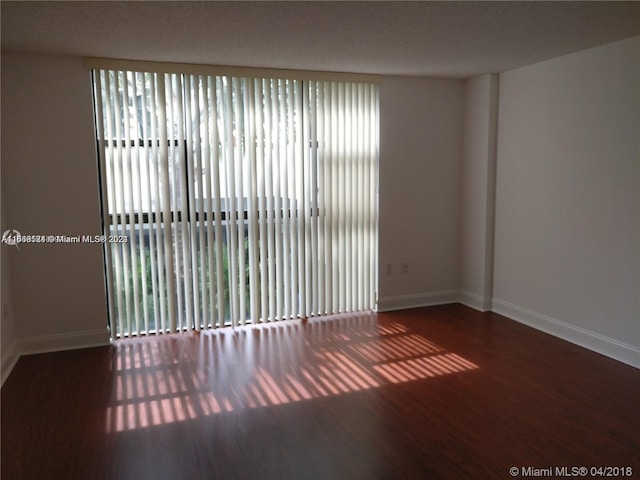 spare room featuring dark hardwood / wood-style flooring