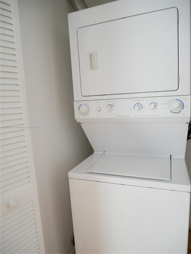 laundry area featuring stacked washer / dryer