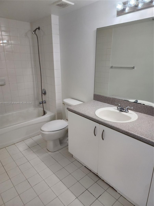 full bathroom with tile patterned flooring, vanity, toilet, and tiled shower / bath