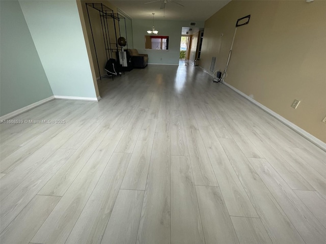 interior space with light wood-style flooring, baseboards, and ceiling fan