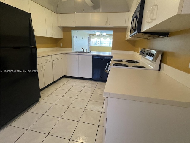 kitchen featuring white cabinets, light countertops, and black appliances