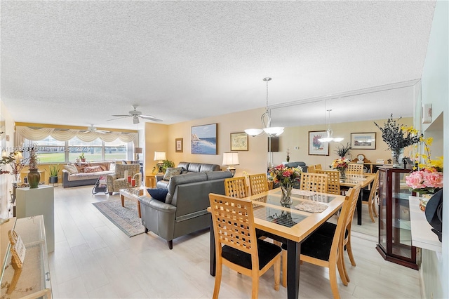 dining room featuring a textured ceiling and ceiling fan