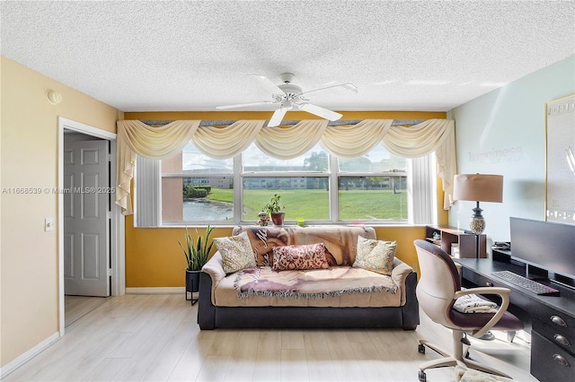 interior space featuring a textured ceiling, light hardwood / wood-style floors, and ceiling fan