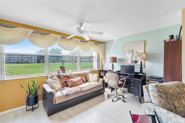 office space featuring a textured ceiling and ceiling fan