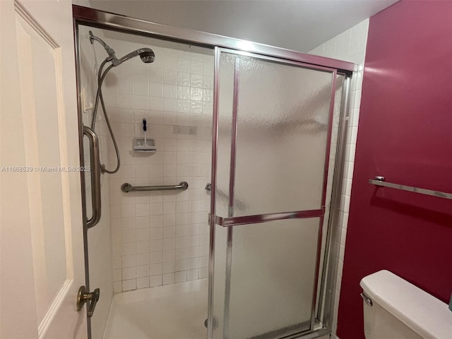 full bath featuring a tile shower and toilet