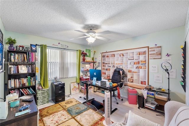 office featuring a textured ceiling and ceiling fan