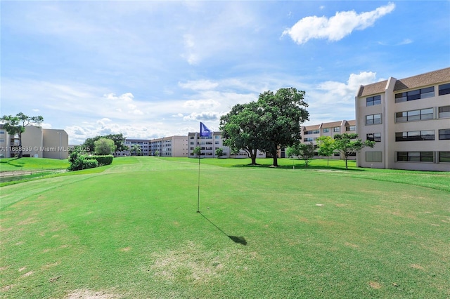 view of property's community with a lawn