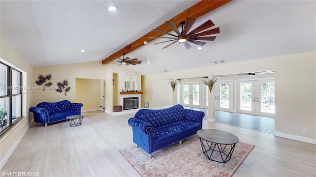 living room with french doors, lofted ceiling with beams, and light hardwood / wood-style flooring