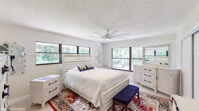 bedroom featuring ceiling fan, a closet, and a textured ceiling