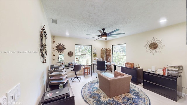 office space with ceiling fan and a textured ceiling