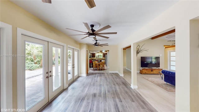 interior space featuring ceiling fan, french doors, and light wood-type flooring