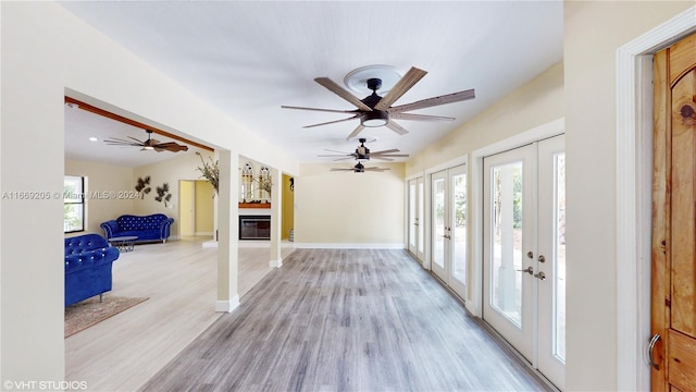 entryway featuring ceiling fan, french doors, and light hardwood / wood-style floors