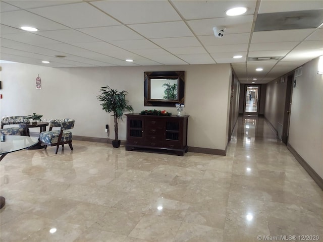 hallway with a drop ceiling