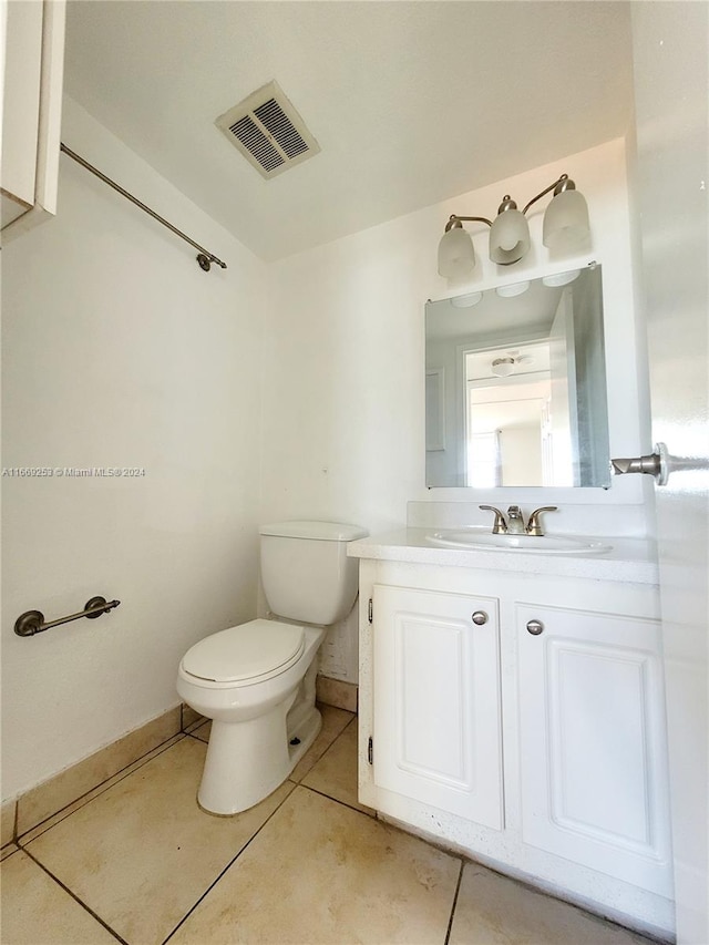 bathroom with tile patterned floors, vanity, and toilet