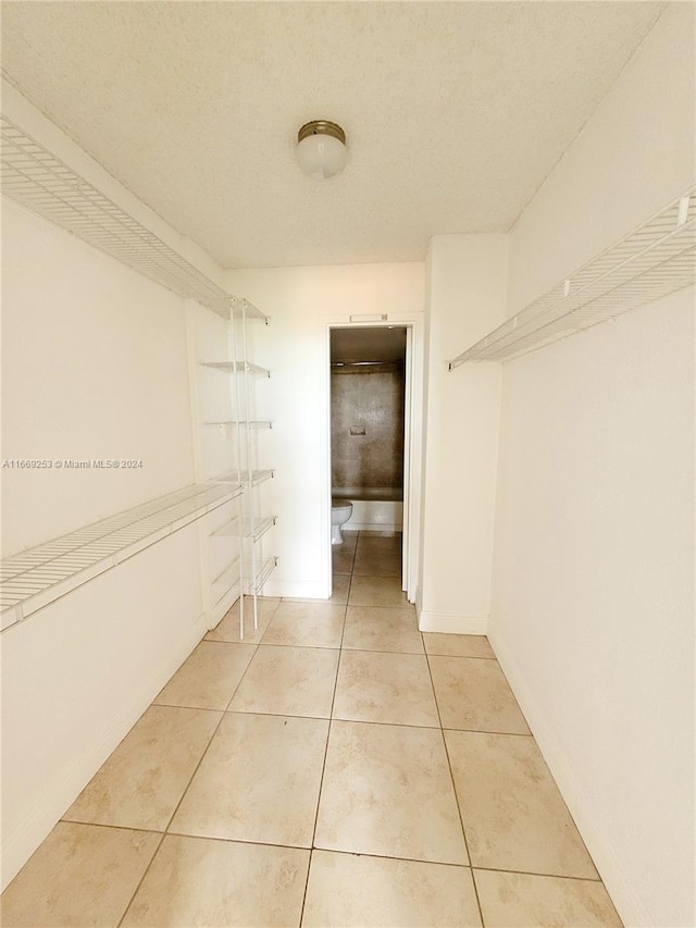 spacious closet with tile patterned floors