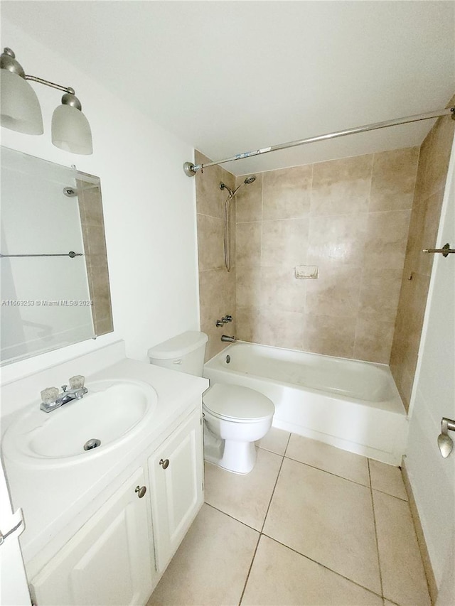 full bathroom with tile patterned floors, tiled shower / bath combo, vanity, and toilet