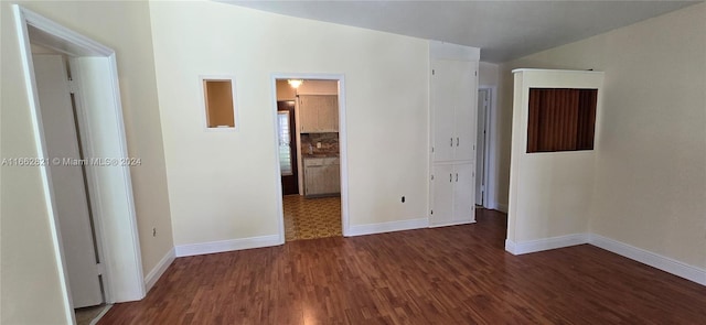 empty room with dark hardwood / wood-style flooring