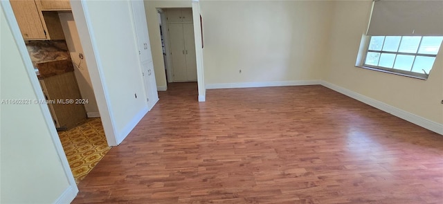 unfurnished bedroom featuring a closet and hardwood / wood-style floors