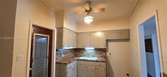 kitchen with ceiling fan, light brown cabinetry, backsplash, and sink