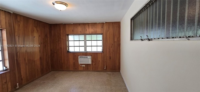 carpeted spare room featuring wooden walls and a wall mounted air conditioner