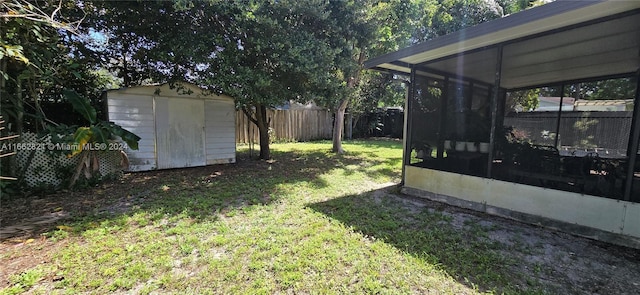 view of yard featuring a storage shed and a sunroom