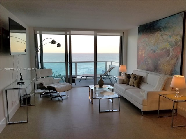 living room featuring a water view and floor to ceiling windows