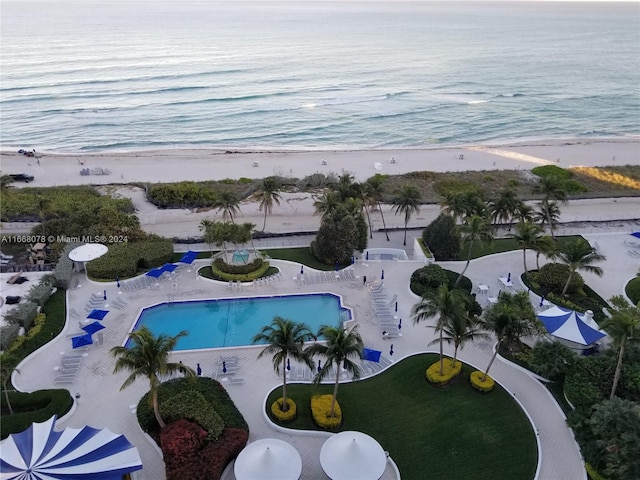 drone / aerial view featuring a beach view and a water view