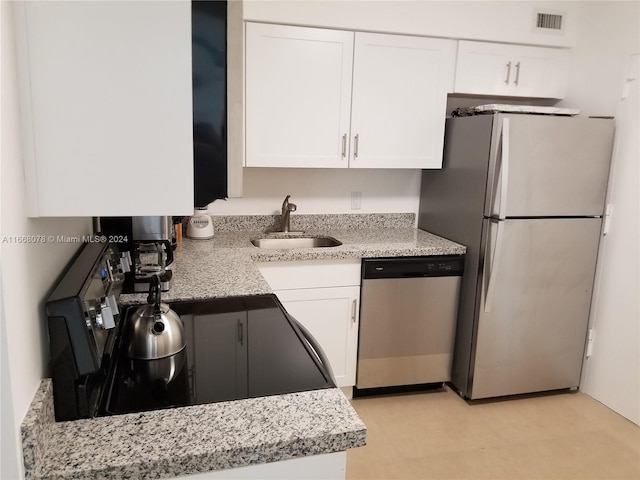 kitchen with white cabinets, appliances with stainless steel finishes, and sink