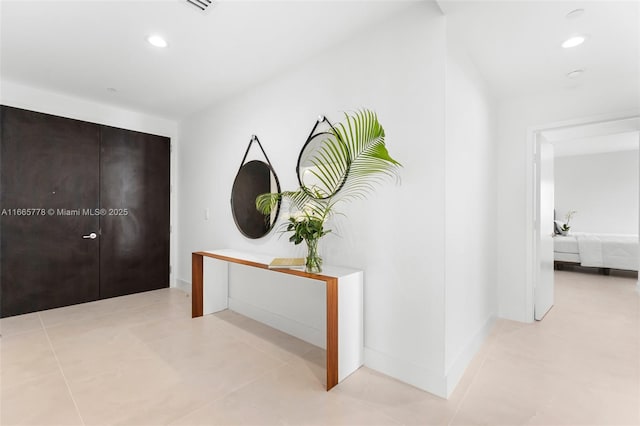 hall featuring light tile patterned flooring