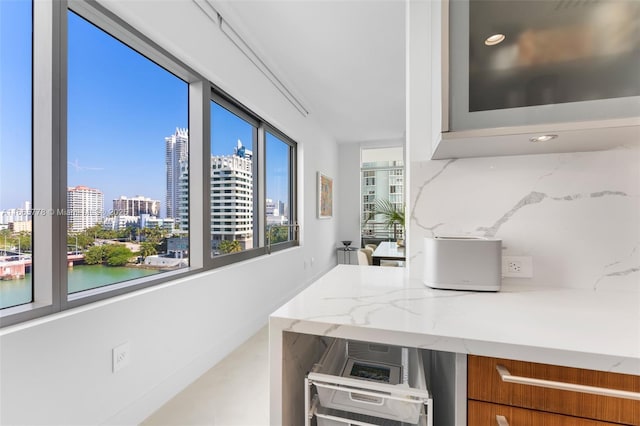 interior space with a water view and tasteful backsplash