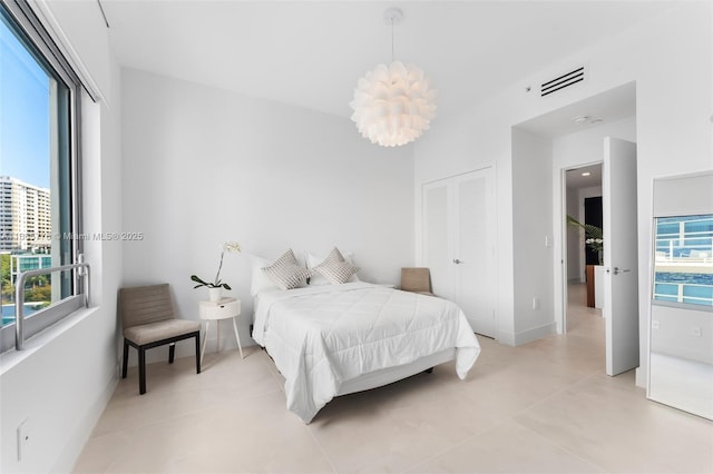 bedroom featuring light tile patterned flooring and a closet