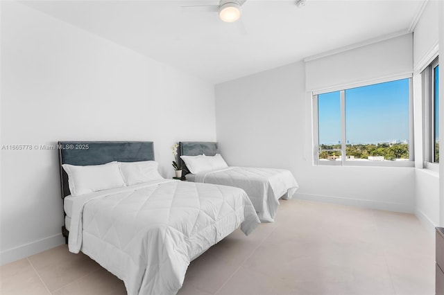 bedroom with ceiling fan and light tile patterned floors