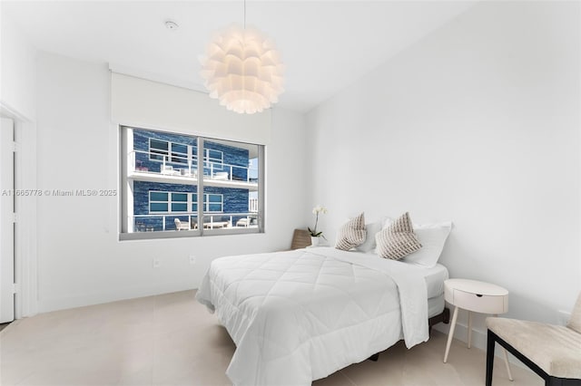 bedroom featuring a notable chandelier